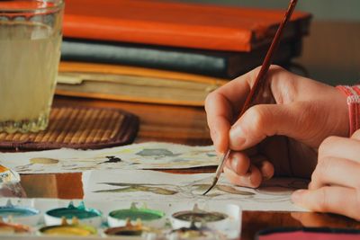 Cropped image of woman painting easter bunny