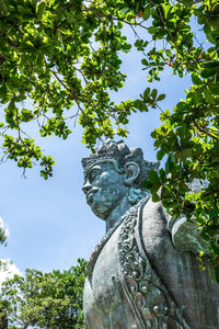 Low angle view of statue against trees