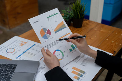 Midsection of businessman working on table