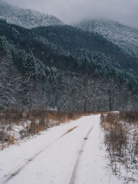 Road by snow covered mountain