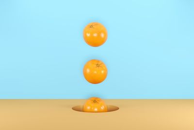 Digital composite image of orange over colored background