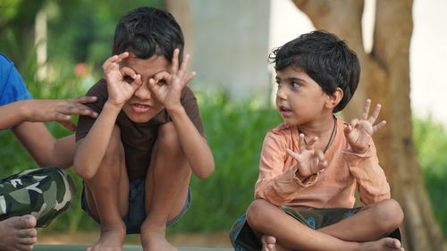 Funny kids doing yoga pose in the park outdoor. healthy life style concept.