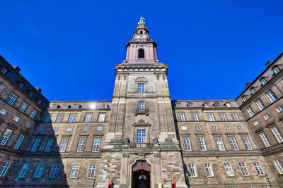 Low angle view of buildings against blue sky