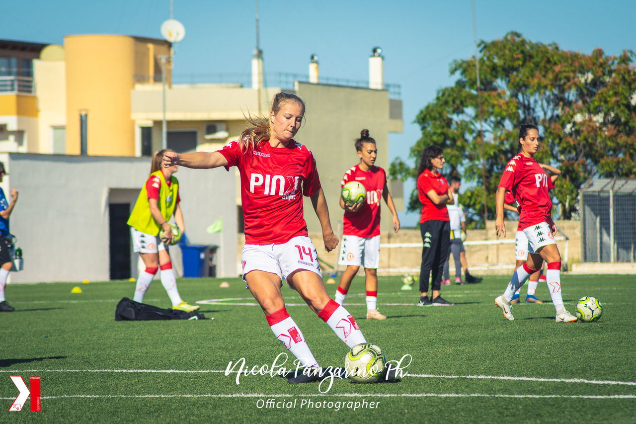 GROUP OF PEOPLE PLAYING SOCCER BALL