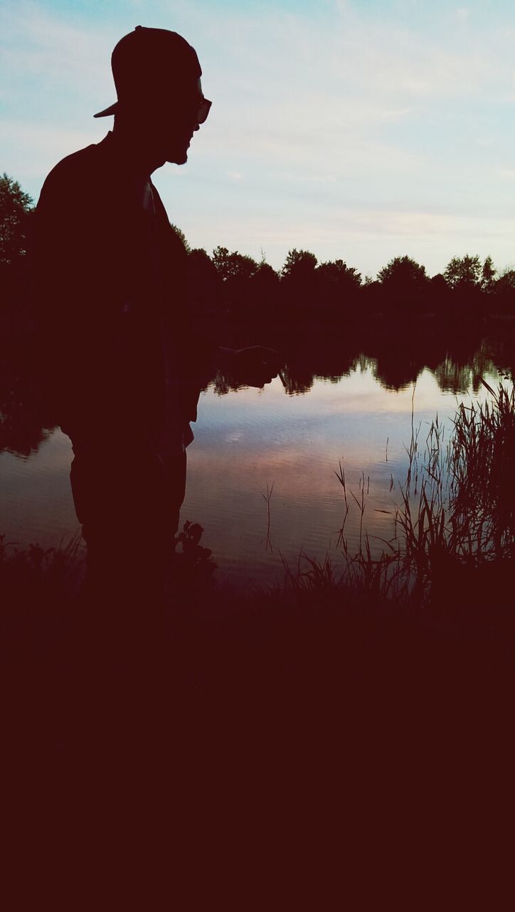 silhouette, sky, water, sunset, tranquility, leisure activity, reflection, tranquil scene, lifestyles, lake, cloud - sky, scenics, nature, standing, men, tree, beauty in nature, cloud