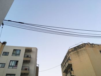 Low angle view of office building against blue sky