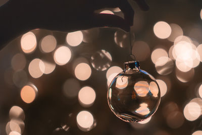 Cropped image of hand holding christmas ornament