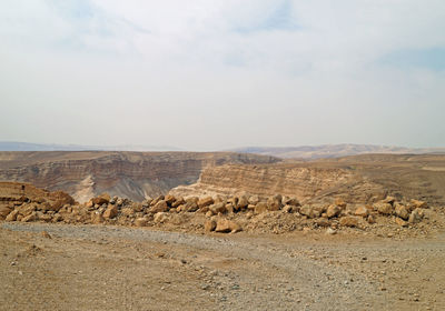 Scenic view of arid landscape against sky