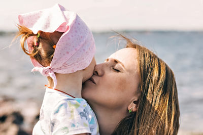 A young mother with a child on the beach.