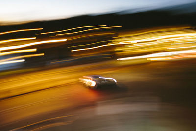 Blurred motion of car on road at night