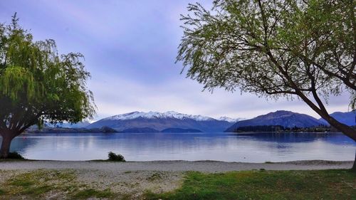 Scenic view of lake and mountains against sky