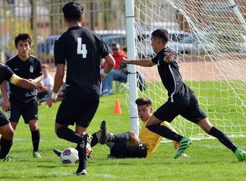 Men playing soccer on field