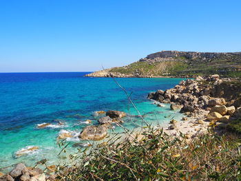 Scenic view of sea against clear blue sky