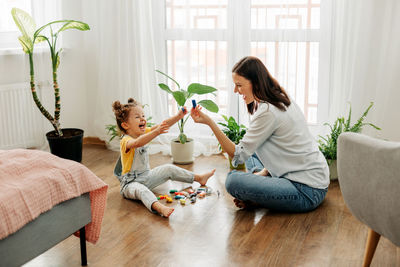 Mom and little daughter choose colorful plasticine for the game. the concept of preschool 