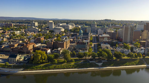 Aerial view of river and buildings against clear sky