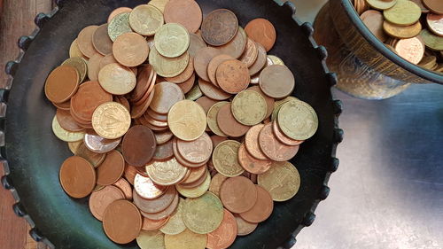 Close-up high angle view of coins in container