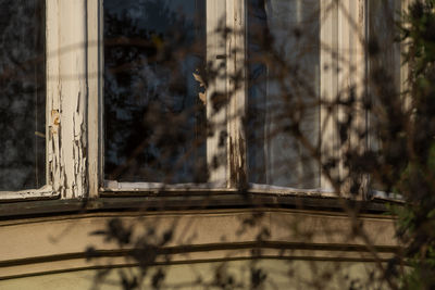 Abandoned building seen through window