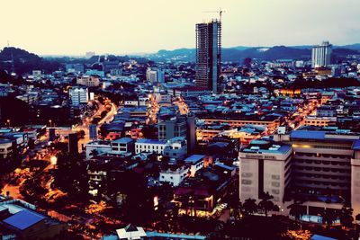 High angle view of illuminated city buildings against sky