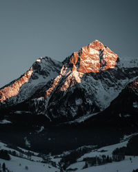 Scenic view of snowcapped mountains against clear sky