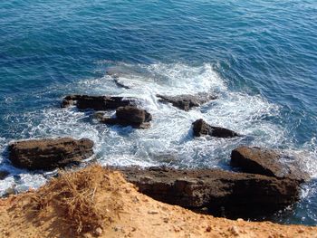 High angle view of rocks in sea