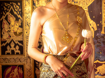 Midsection of woman holding umbrella