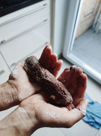 Close-up of hand holding meat