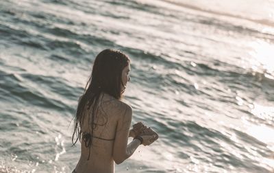 Woman looking at sea shore