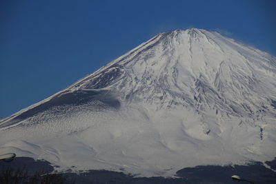 Scenic view of snow covered mountain against cloudy sky