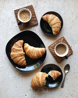 High angle view of coffee and croissants on stone table