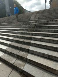 Rear view of woman walking on staircase