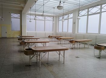 Empty chairs and table in room