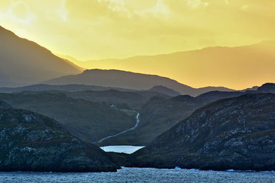 Scenic view of mountains against sky during sunset