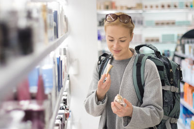 Mid adult woman looking away at store