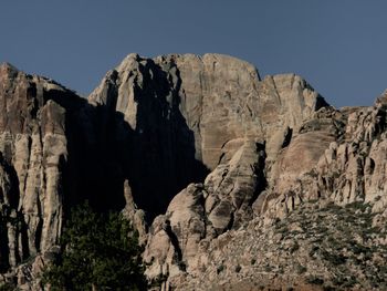 Rock formations on mountain against clear sky