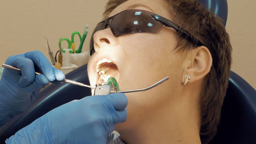 Cropped image of dentist examining patient