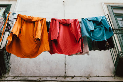 Low angle view of clothes drying outside building