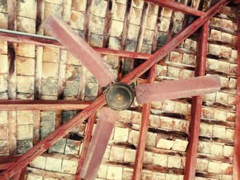 Low angle view of metallic structure against wall