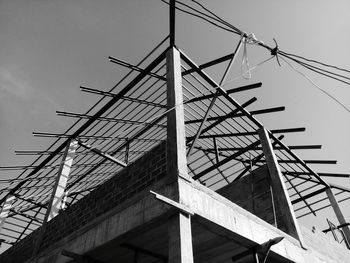 Low angle view of crane against sky