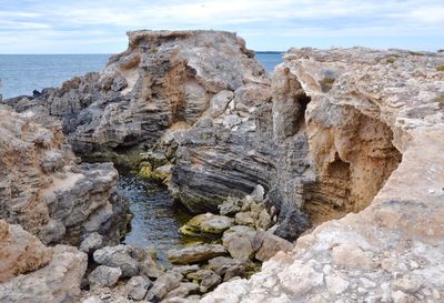 Rock formation by sea against sky at cape peron