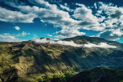 Scenic view of mountain against cloudy sky