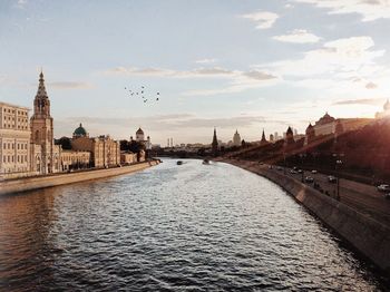 View of river and buildings against sky