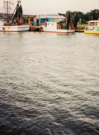 Boats moored on sea against sky