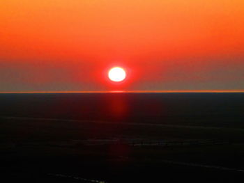 Scenic view of sea against orange sky