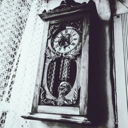 Low angle view of clock on wall