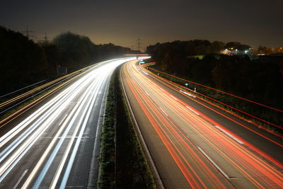 High angle view of light trails on highway at night