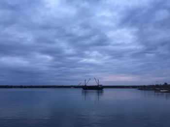 Scenic view of lake against dramatic sky