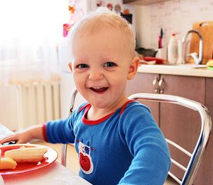 Portrait of happy boy with food on table