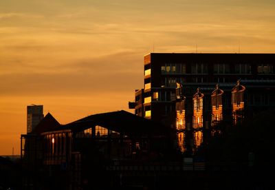 Silhouette of building against sky during sunset