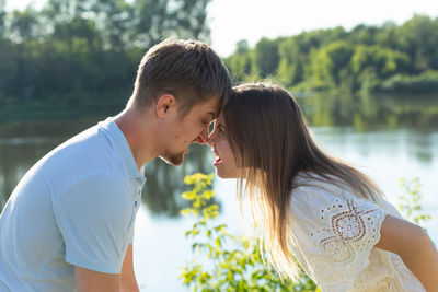 Side view of woman against lake