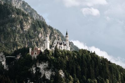 Panoramic view of trees and buildings against sky